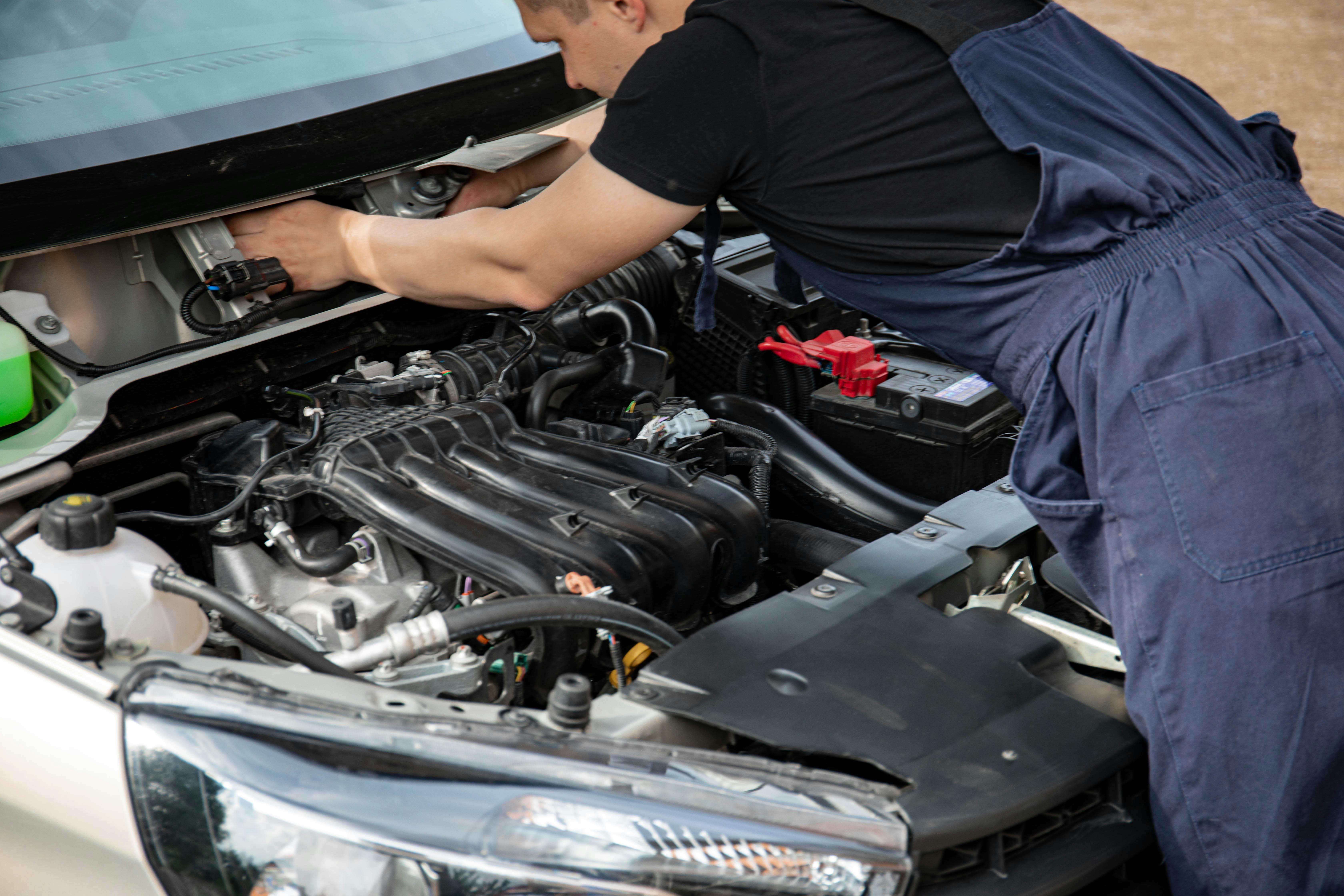 Mobile mechanic servicing a vehicle outdoors